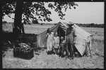 Veteran migrant agricultural worker and his family encamped on the Arkansas River, Wagoner County, Oklahoma. 1939.